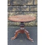 A 19th Century circular wine table, the Georgian mahogany one piece top raised upon a Victorian