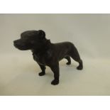 A bronzed figure of a Staffordshire bull terrier suitable as a doorstop.