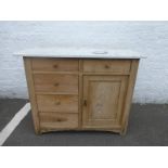 A pine marble topped wash stand of five drawers and a single cupboard base.