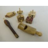An assortment of ivory whistles and spinning dice etc.