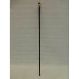 An ebonised walking cane with yellow metal, possibly rose gold floral decorated knop, stamped A.H.