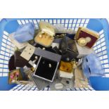 A basket of assorted costume jewellery, mostly earrings including silver.
