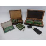 An assortment of 19th Century cased scientific slides.