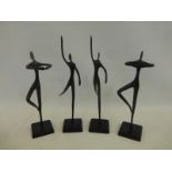 A group of four contemporary dancing metal figures.