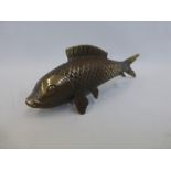 A bronzed cast metal figure of a koi carp.