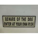 A cast metal wall mounted "Beware of the Dog Enter At Your Own Risk" plaque.