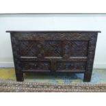 An early 18th Century West Country mule chest/coffer, the rising lid above a profusely carved