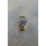 An 18ct gold and nine stone diamond ring, maker J & P, Sheffield hallmark, total weight 6.6g.