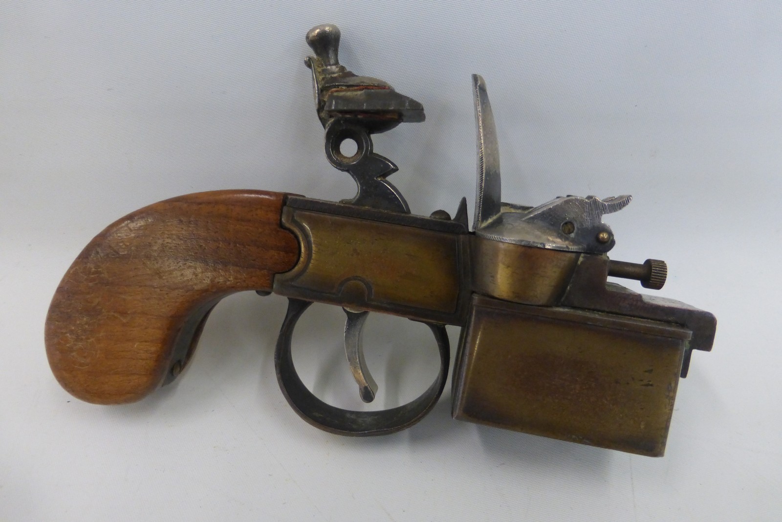 A Dunhill tinder pistol lighter.