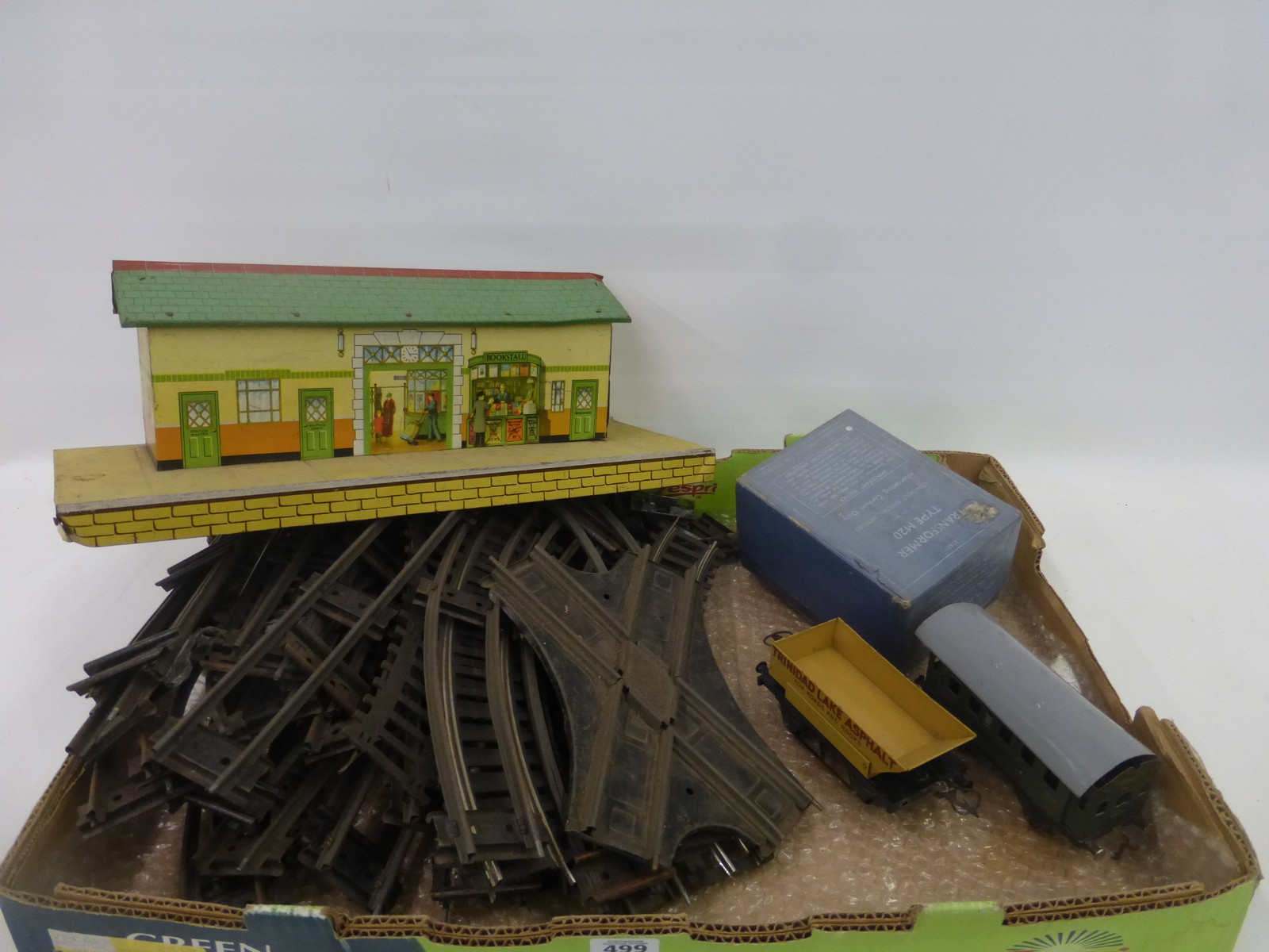 An assortment of 0 gauge track, a Fleischmann tin plate carriage made in the U.S. Zone Germany, a