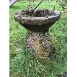 A large period stone staddle stone with reconstituted bird bath as the cap.