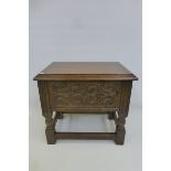A contemporary oak jointed workbox/stool with carved panel front and sides, with rising lid,
