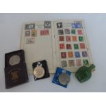 A stamp album and commemorative coinage including a 1951 crown.