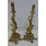 A pair of Rococco style cherubic table lamps possibly French.