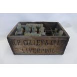 A Worthington R.P. Culley & Co. Ltd Liverpool wooden crate and an assortment of glass bottles.