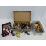 Three boxes of assorted costume jewellery including bangles, beads etc.