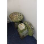 A pair of staddle stones with tops (weathered).