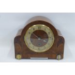 An Art Deco inlaid walnut cased chiming mantel clock stamped Haller to the movement.