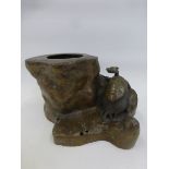An Oriental brass incense stand/ burner (possibly Chinese) in the form of a hollowed tree trunk with