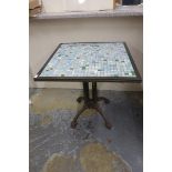 A conservatory/garden table with a mosaic top and brass surround raised on a 19th Century cast metal