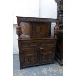 A reproduction 18th Century style carved oak court cupboard, the carved upper section with a