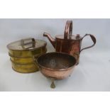 A 19th Century copper watering can, a copper and brass strainer and a 19th Century brass three