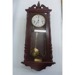 A contemporary mahogany cased wall clock.