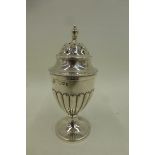A silver pepperette of "Adam" urn style, London 1892, by Carrington & Co.