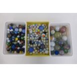 Three boxes of unusual marbles of various sizes.