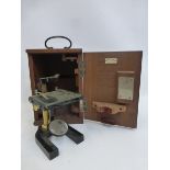 A mahogany cased C. Baker 244 High Holborn, London microscope with retailer's label Millikin and