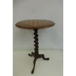 A Victorian mahogany circular chess board occasional table with barley twist column to a tripod