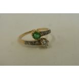 A precious yellow metal (probably 18ct gold and platinum), emerald and diamond dress ring, the