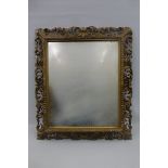 An 18th Century well carved giltwood framed wall mirror.