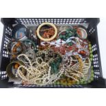 A box of assorted costume jewellery including opaline, coral, beads, bangles, etc.
