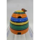 A Clarice Cliff Newport Pottery-Wilkinson Ltd Bizarre honey pot and lid surmounted with bumble bee