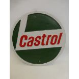 A circular cast metal Castrol wall plaque.