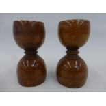 A pair of 19th Century double ended treen egg cups one with a faint inscription, the other stamped