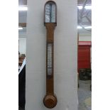 A George III stick barometer, the glazed arched top enclosing the barometer with ivory panels