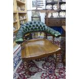 A Victorian oak tub chair with buttoned green leather upholstered top rail and barley twist supports