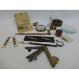 A box of mixed collectables including a brass gauge, a parallel rule, magnifying glasses, apothecary