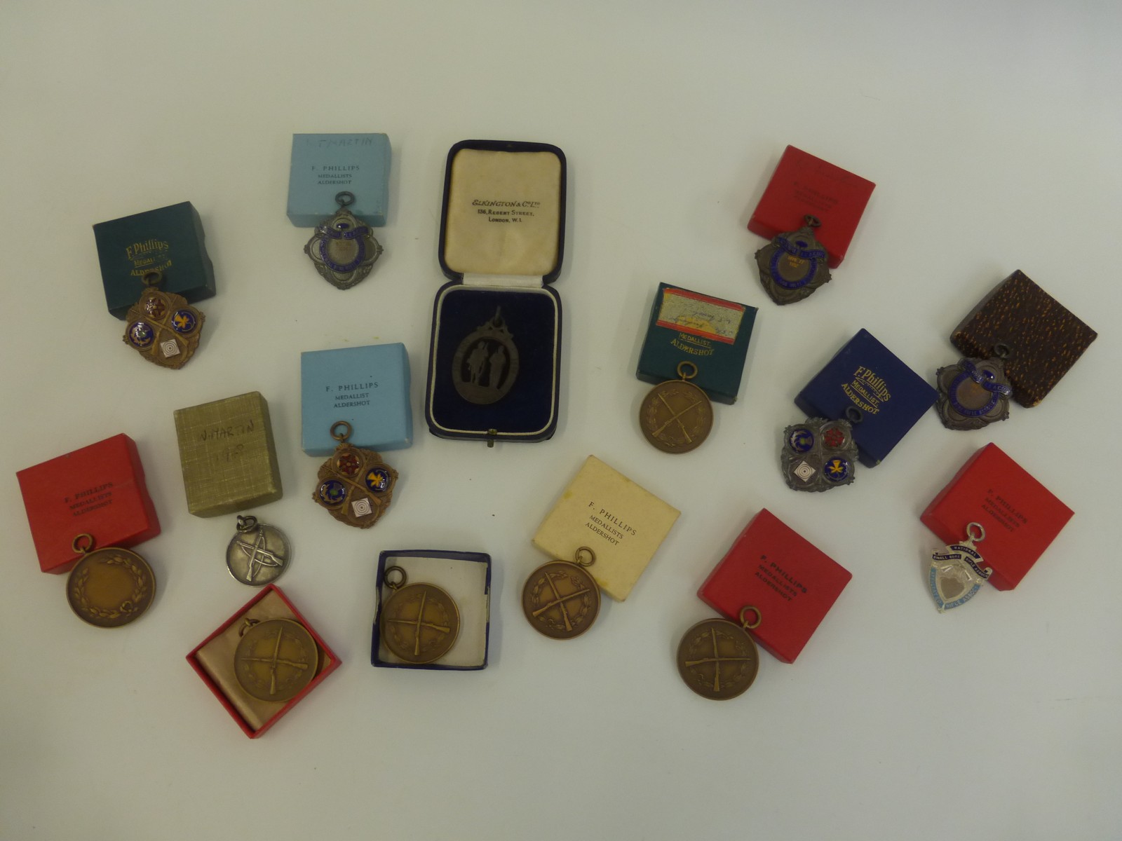 A collection of mostly 1950s shooting medals including enamel and silver.