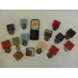 A collection of mostly 1950s shooting medals including enamel and silver.