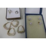 An assortment of 9ct gold earrings including hooped and stud earrings.
