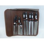 A cased nine piece Waltham knife set and carrying bag (L369).
