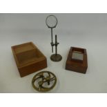 A Hilger Watts steel boxed weight O.C. No.2, a boxed brass gauge and a fly makers magnifying glass.
