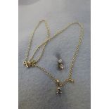 A pair of 9ct gold solitaire diamond stud earrings and pendant necklace.