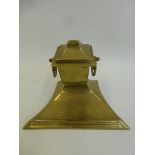 An Art Nouveau brass desk top ink well with ceramic well.