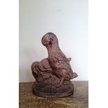 A cast iron duck doorstop with old painted finish.