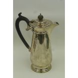 A silver coffee pot with ebonised handle and finial, maker - James Woods & Sons, Birmingham 1925.