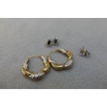 Three pairs of 9ct gold and CZ set earrings including a pair of 9ct gold hooped earrings.